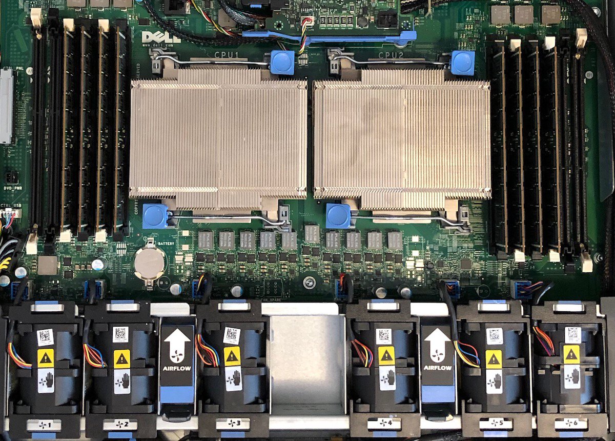 The inside of a Dell
server. Two CPU coolers, eight sticks of memory, and a bank of small fans
are visible.